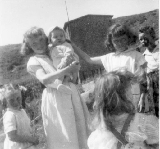 683: l-r Rosemary Norman, Geraldine Norman holding baby Calvin Kerrivan, Hilda Norman and William  Norman, with Elizabeth Lambe in front (back to camera). At Margarees Cove, Red Island. (circa 1956) [courtesy of Jenny (Kerrivan) Harvie]  - Rosemary, Geraldine, Hilda and William children of Michael Norman &amp;amp; Elizabeth Counsel; Calvin  son of Leo Kerrivan &amp;amp; Sarah Norman; Elizabeth daughter of Patrick Lambe &amp;amp; Mary Kerrivan